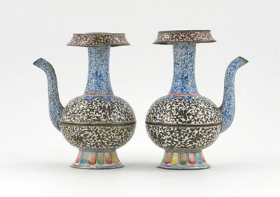 Appraisal: A pair of Chinese Canton enamel ewers decorated with an