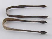 Appraisal: Two pairs of Georgian silver bright cut tongs one Peter