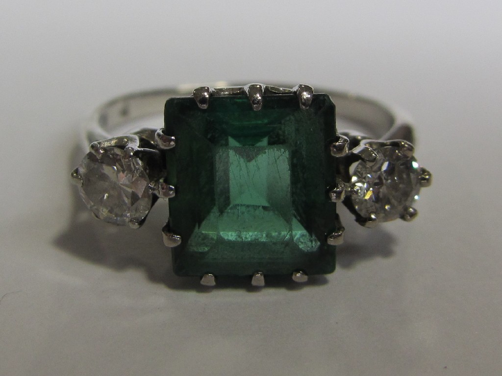 Appraisal: A platinum emerald and diamond three stone ring with step