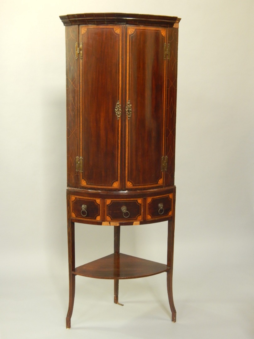 Appraisal: A George III mahogany and satinwood inlaid bow front corner