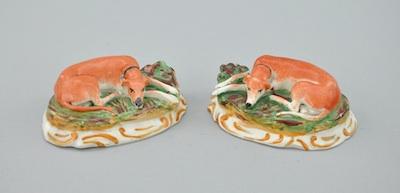 Appraisal: A Pair of Staffordshire Porcelain Whippet Figurals Each resting on