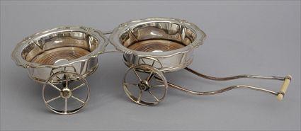 Appraisal: ENGLISH SILVER-PLATE TWO-BOTTLE WAGON The wood base coasters with serpentine