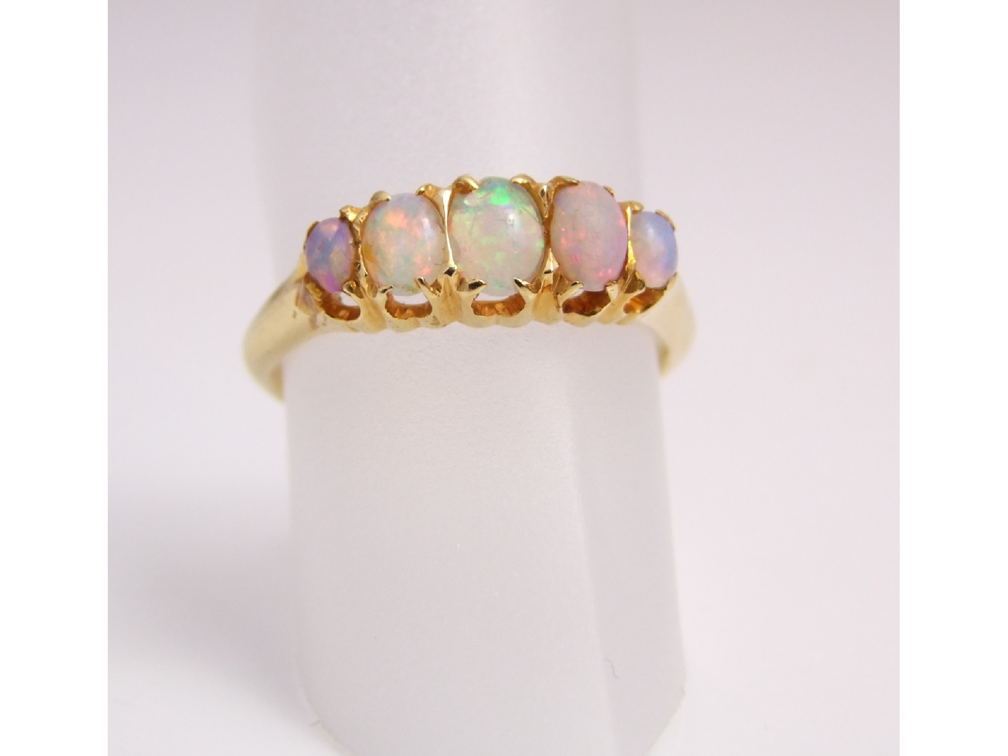 Appraisal: An Edwardian opal ring set with five graduated oval opals