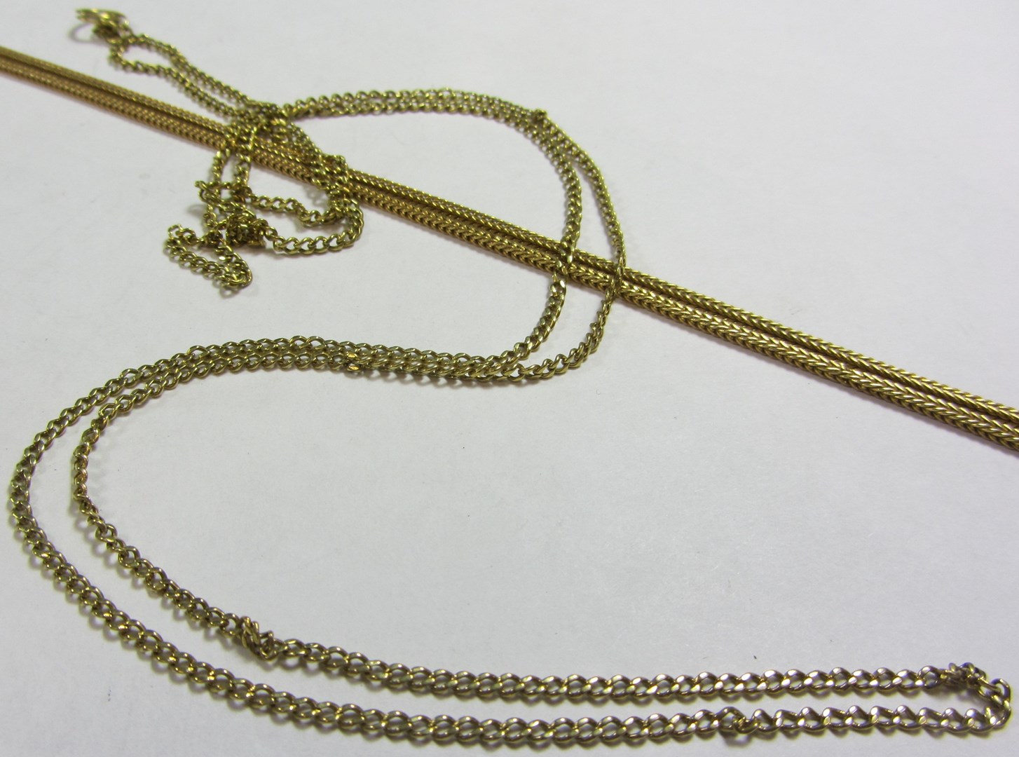 Appraisal: A gold foxtail link neckchain detailed and a gold curb