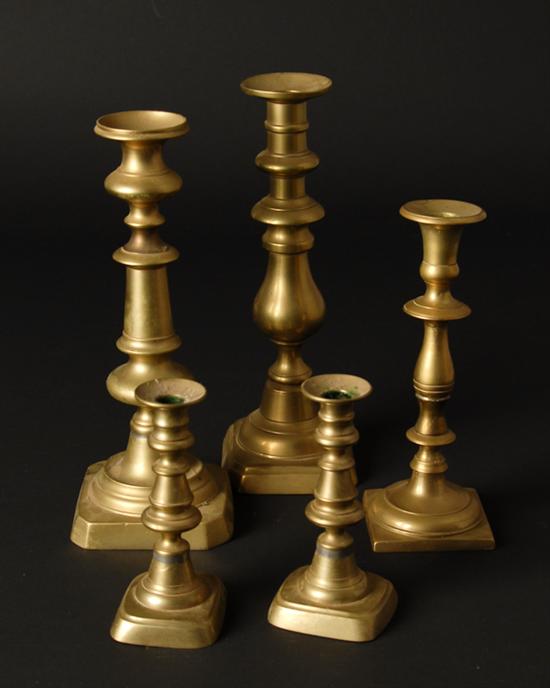 Appraisal: Five Early Brass Candlesticks one pair of tall push-ups with