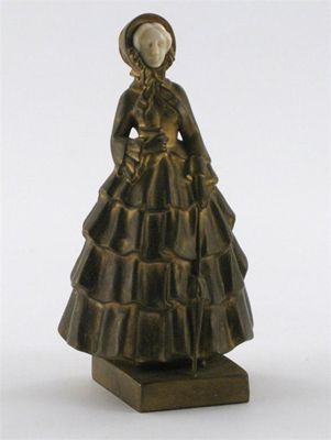 Appraisal: A gilt bronze and ivory figure of a lady cast