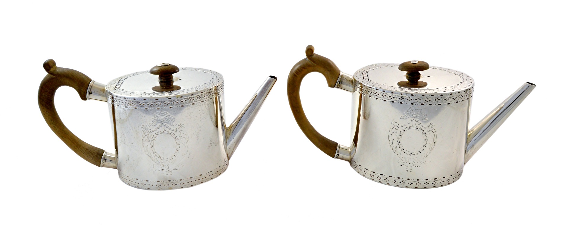 Appraisal: A pair of George III oval silver teapots William Vincent