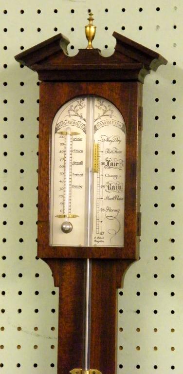 Appraisal: Mahogany stick barometer thermometer with a broken arch top surmounted