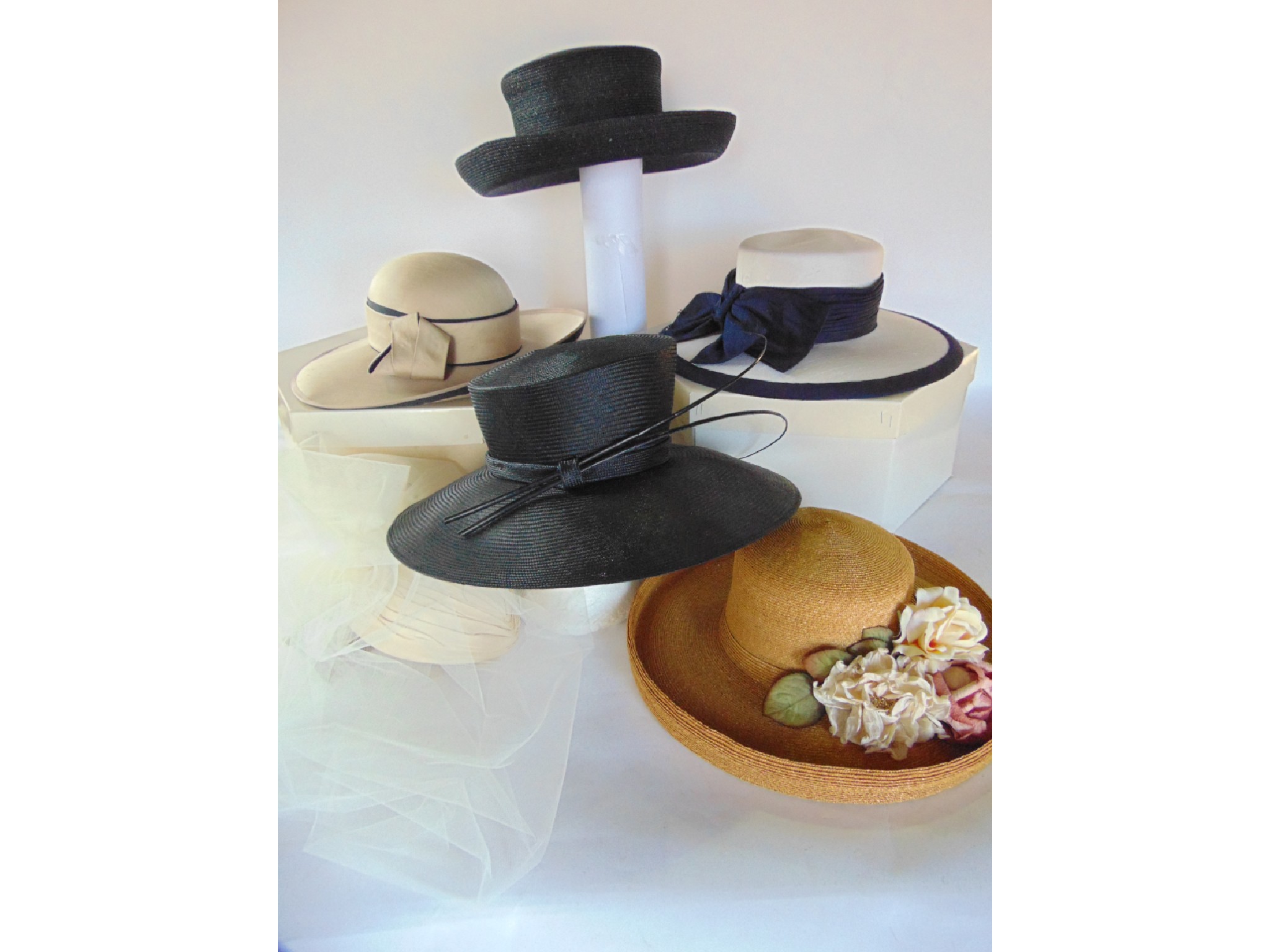 Appraisal: A collection of ladies hats including a natural straw summer