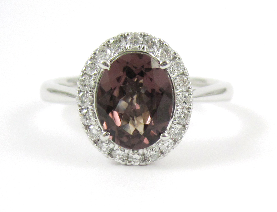 Appraisal: HESSONITE DIAMOND AND FOURTEEN KARAT WHITE GOLD RING with round-cut