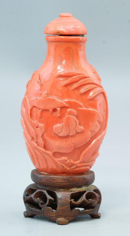 Appraisal: Chinese Carved Coral Colored Peking Glass Snuff Bottle depicting a