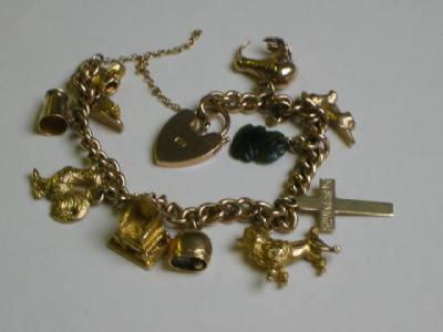 Appraisal: A CT GOLD CHARM BRACELET of flattened curb link hanging