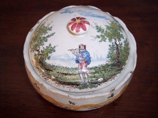 Appraisal: A tin glazed powder pot the lid decorated a musician