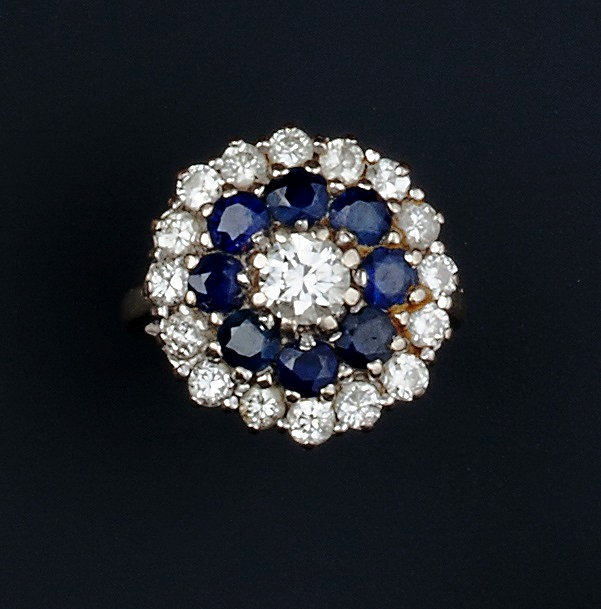 Appraisal: A SAPPHIRE AND DIAMOND TARGET CLUSTER RING the central round