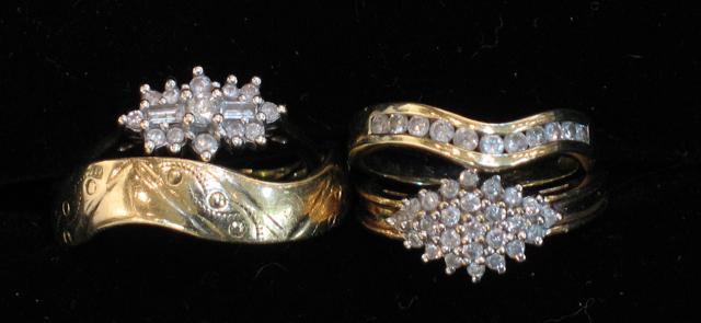 Appraisal: TWO DIAMOND CLUSTER RINGS a shaped tension-set diamond half eternity