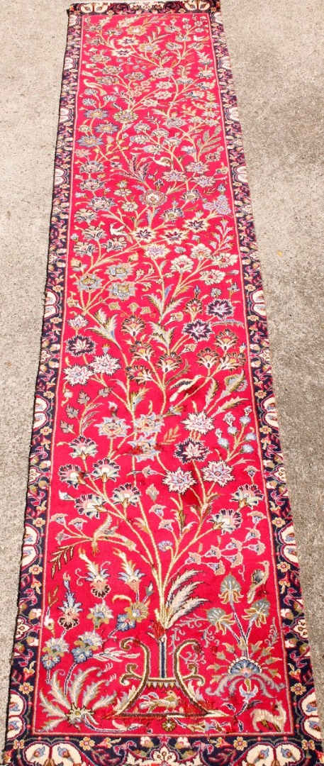 Appraisal: A Mashad runner in red cm x cm