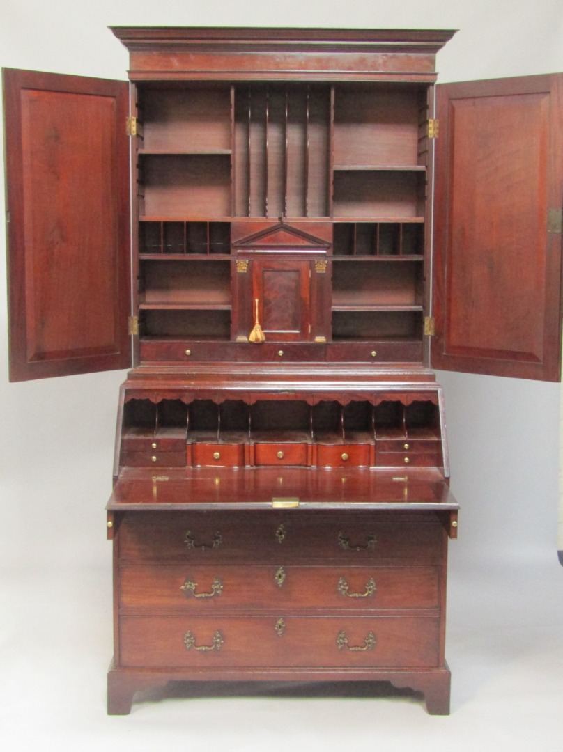 Appraisal: A George III mahogany bureau cabinet the outswept pediment above