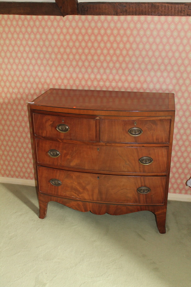 Appraisal: A Regency flamed mahogany bow front chest of two short