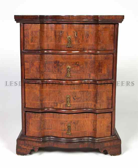 Appraisal: A Continental Diminutive Chest of Drawers having a serpentine front