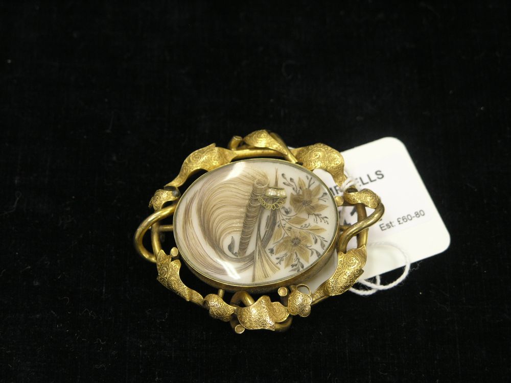 Appraisal: A Victorian pinchbeck brooch engraved detail centre inset with hair