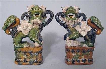 Appraisal: Two pairs of Chinese sancai glazed Fu-lions Both pairs modeled