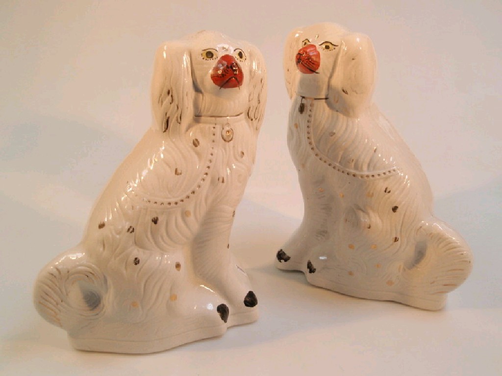 Appraisal: A pair of Victorian Staffordshire spaniels with gold splash decoration