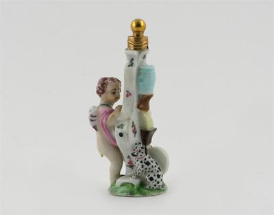 Appraisal: A Girl-in-a-Swing scent bottle modelled as Cupid sharpening his arrows