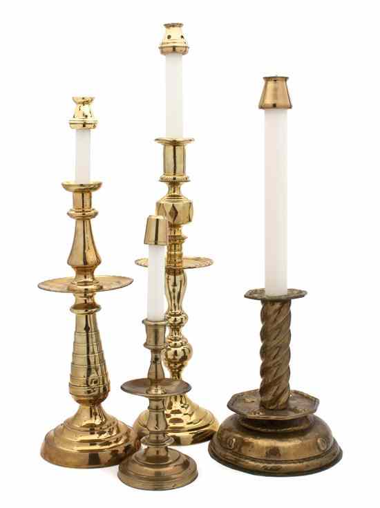 Appraisal: A Group of Four Brass Candlesticks of various sizes and