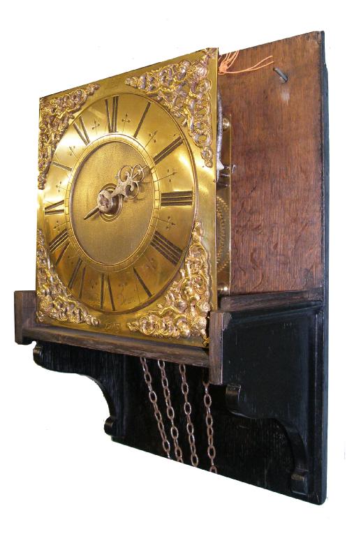 Appraisal: Interesting thirty hour oak hooded wall clock the square brass