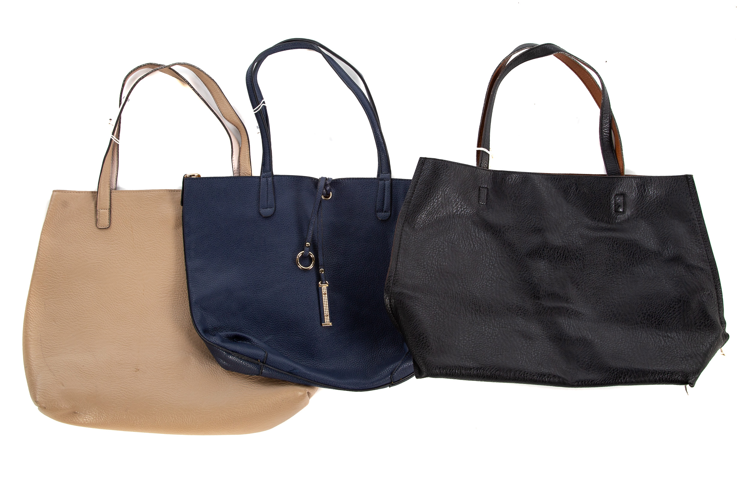 Appraisal: THREE REVERSIBLE LEATHER HANDBAGS one from beige to shell pink