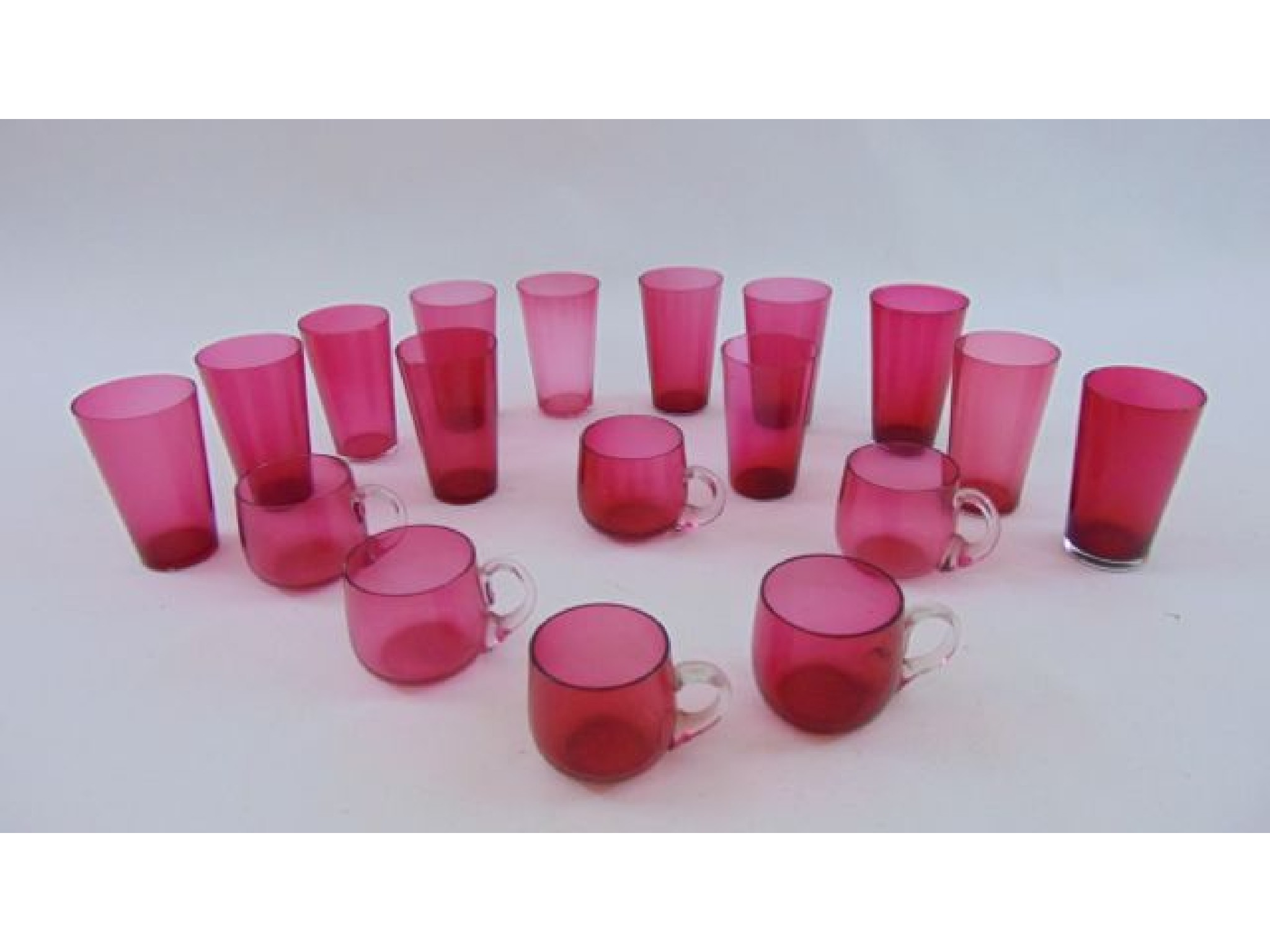 Appraisal: Twelve cranberry glass beakers of tapering cylindrical form together with