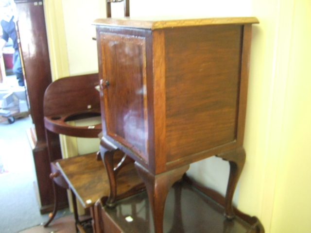 Appraisal: A walnut pot cupboard with geometric satin borders and cabriole