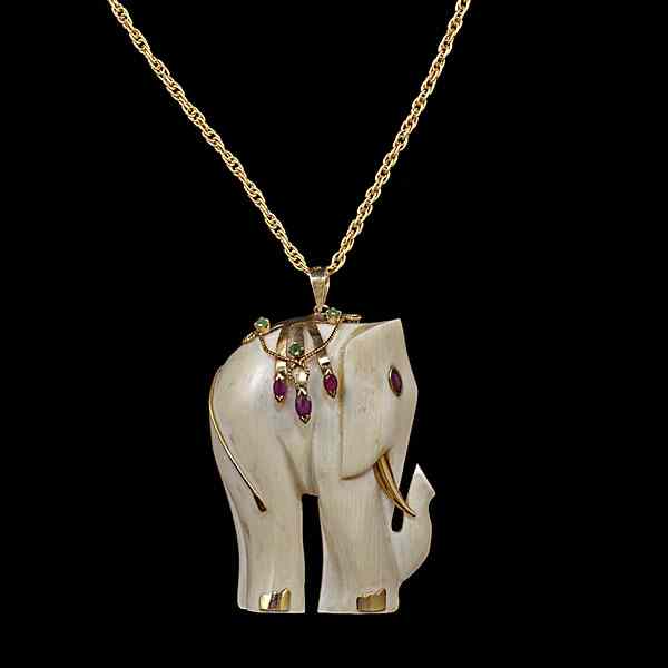 Appraisal: Carved Ivory Elephant Pendant with Rubies and Emeralds A carved