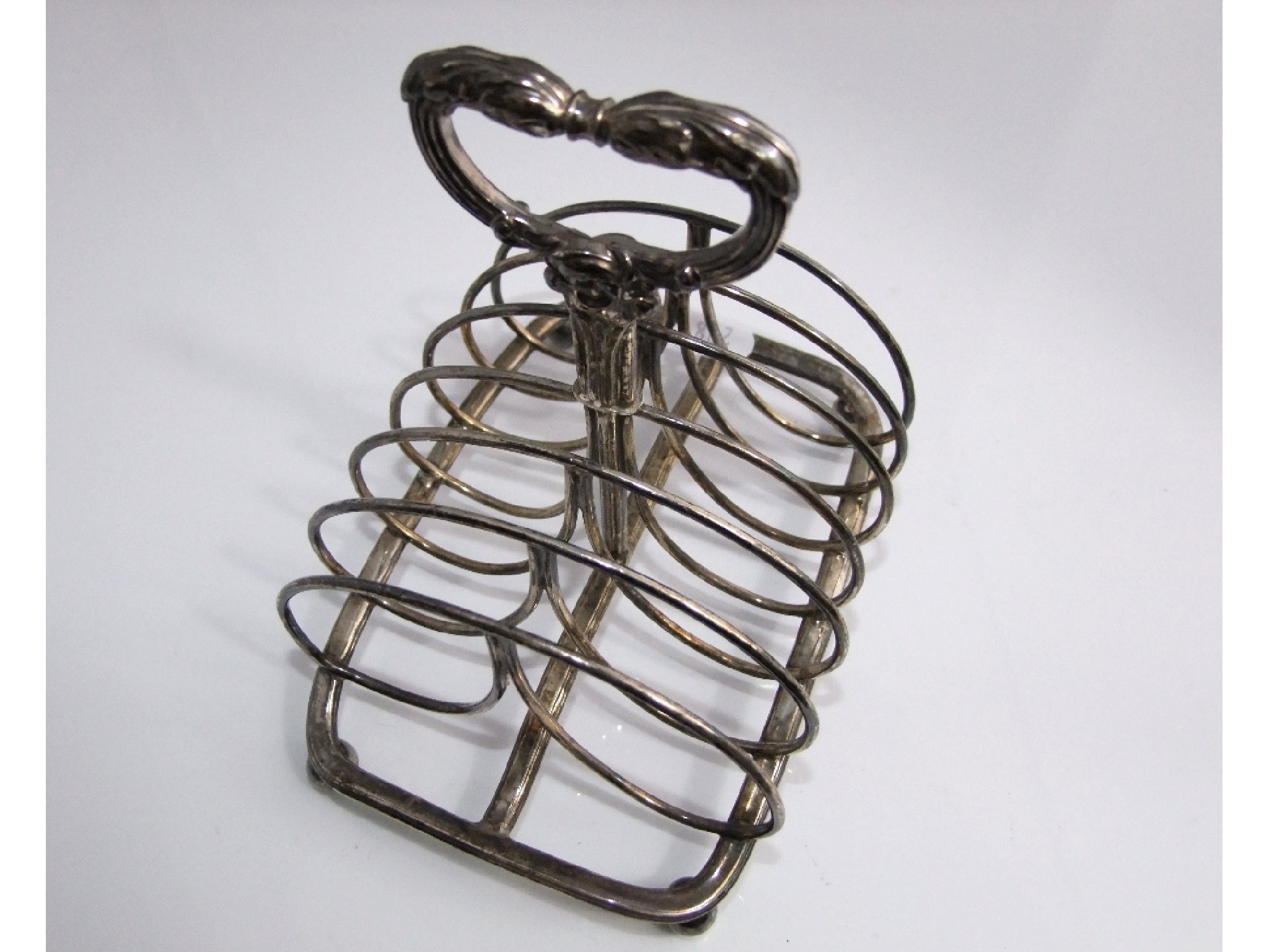 Appraisal: A William IV silver six divisional toast rack with central