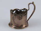 Appraisal: A Russian silver teaglass holder with scroll handle and pierced