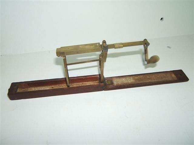 Appraisal: A GEORGE III MAHOGANY AND BRASS FOLDING GUINEA SCALE with