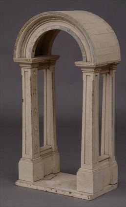 Appraisal: NEOCLASSICAL-STYLE CARVED AND IVORY-PAINTED NICHE The arched crest on angular