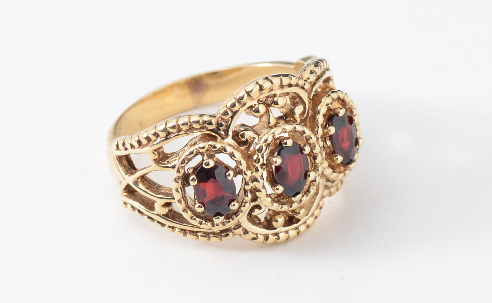 Appraisal: THREE STONE GARNET RING Etruscan style K yellow gold ring