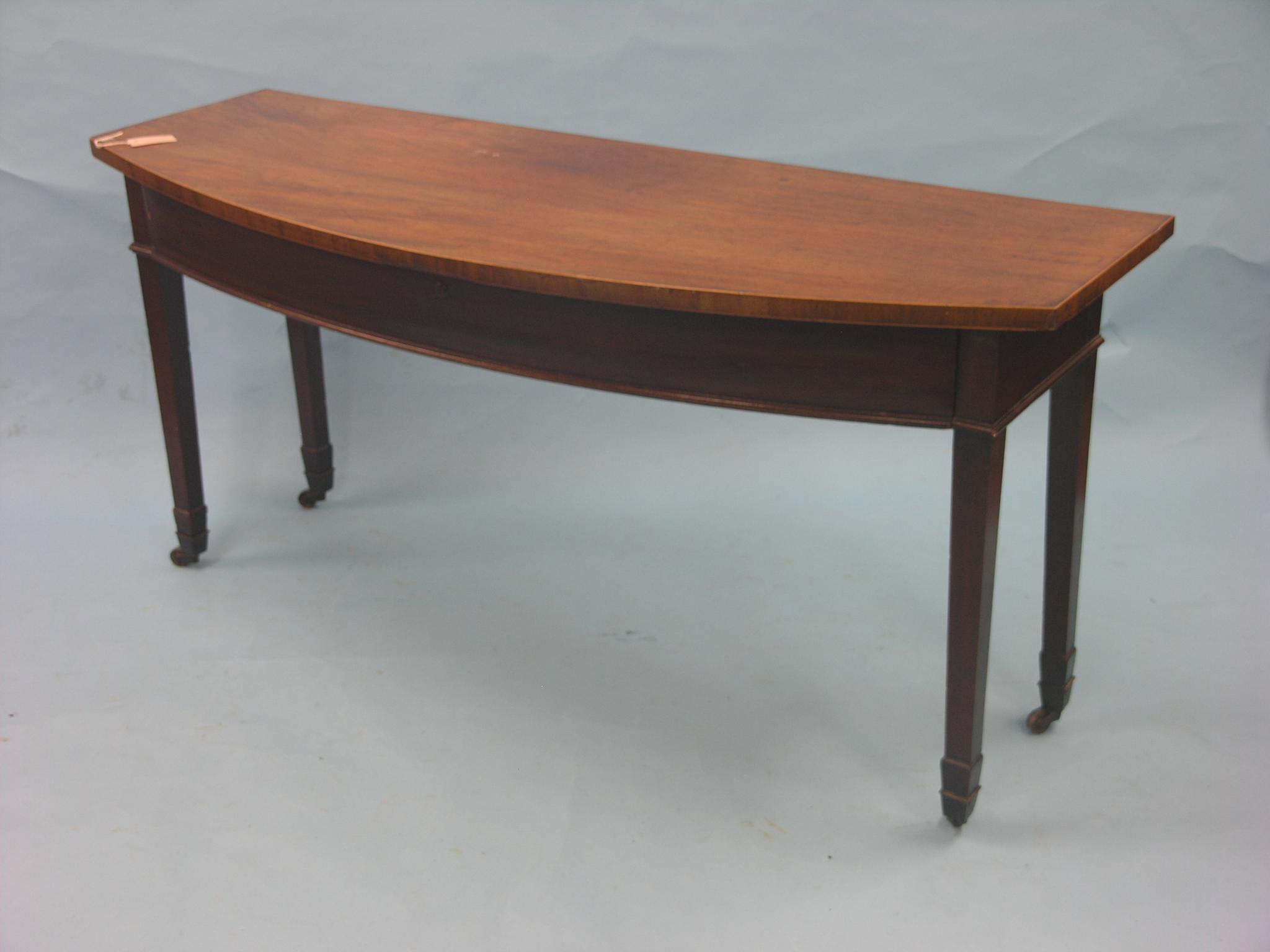 Appraisal: A large mahogany serving table bow-fronted with single oak-lined frieze