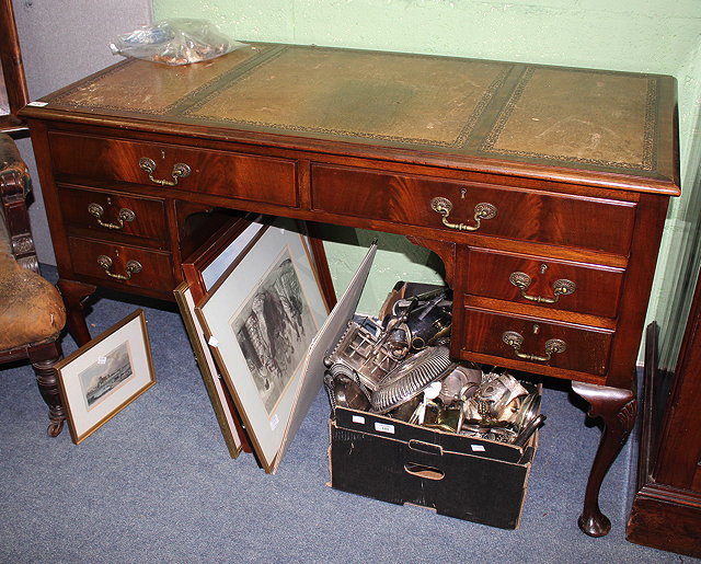 Appraisal: A MAHOGANY WRITING DESK with triple leather inset top and