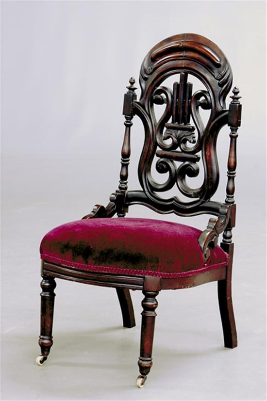 Appraisal: Gothic Revival carved rosewood side chair pierced lyre-back flanked by