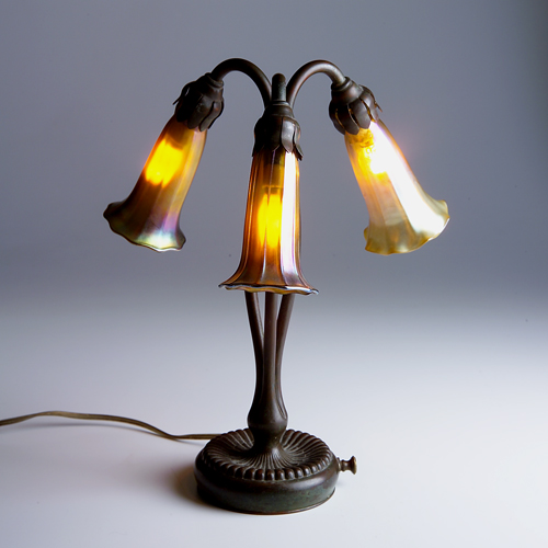 Appraisal: TIFFANY STUDIOS Three-light Lily lamp with one Tiffany style shade