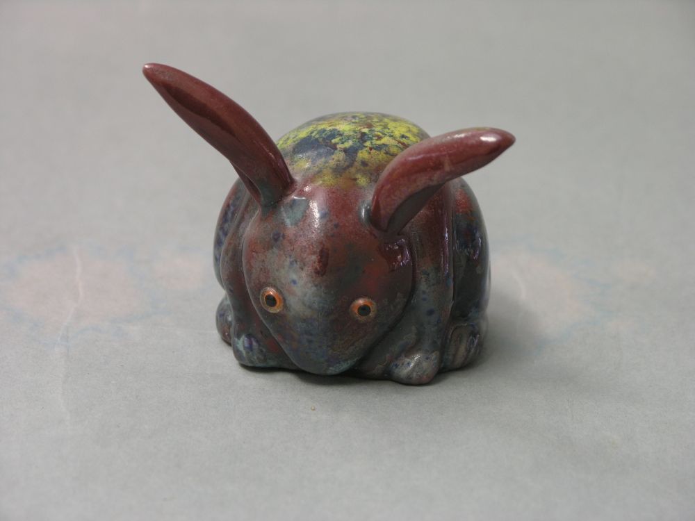 Appraisal: A Bernard Moore flambe rabbit model bold colouring and glaze