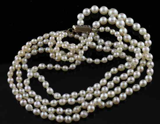 Appraisal: An Edwardian double strand graduated natural pearl necklace with diamond