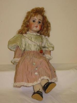 Appraisal: A German bisque head girl doll with fixed brown glass