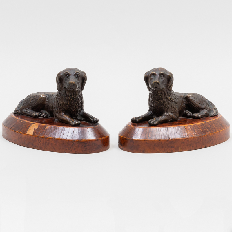 Appraisal: PAIR OF CAST METAL RECUMBENT DOGS ON INLAID WOOD BASES