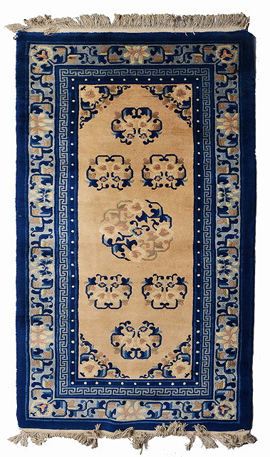 Appraisal: A CHINESE BLUE AND WHITE WOOLLEN RUG with stylised foliate