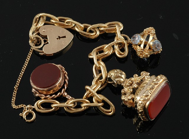 Appraisal: A GOLD CHARM BRACELET The fancy open link ct gold