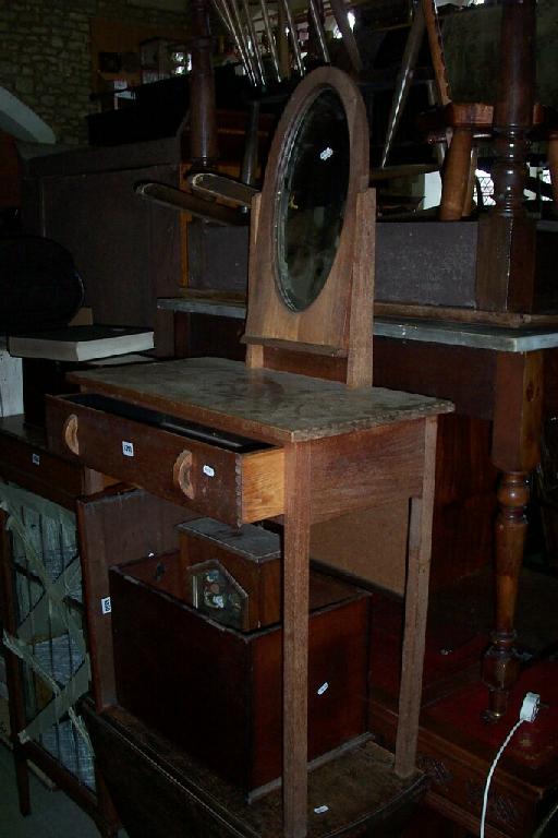 Appraisal: A Cotswold School dressing table with frieze drawer raised on