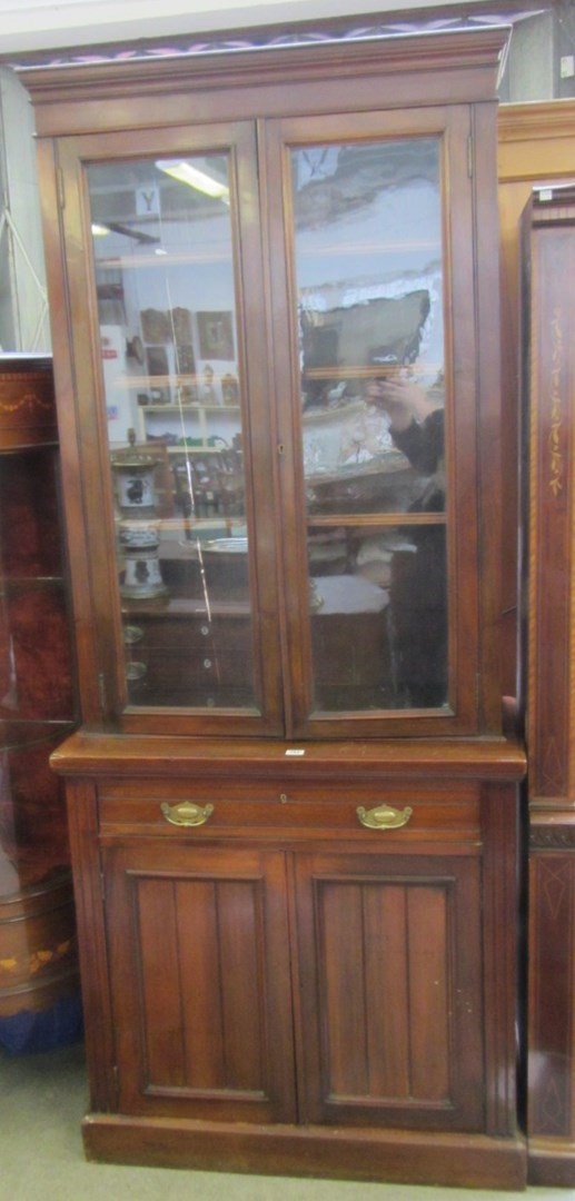 Appraisal: A late Victorian mahogany bookcase cupboard the pair of glazed